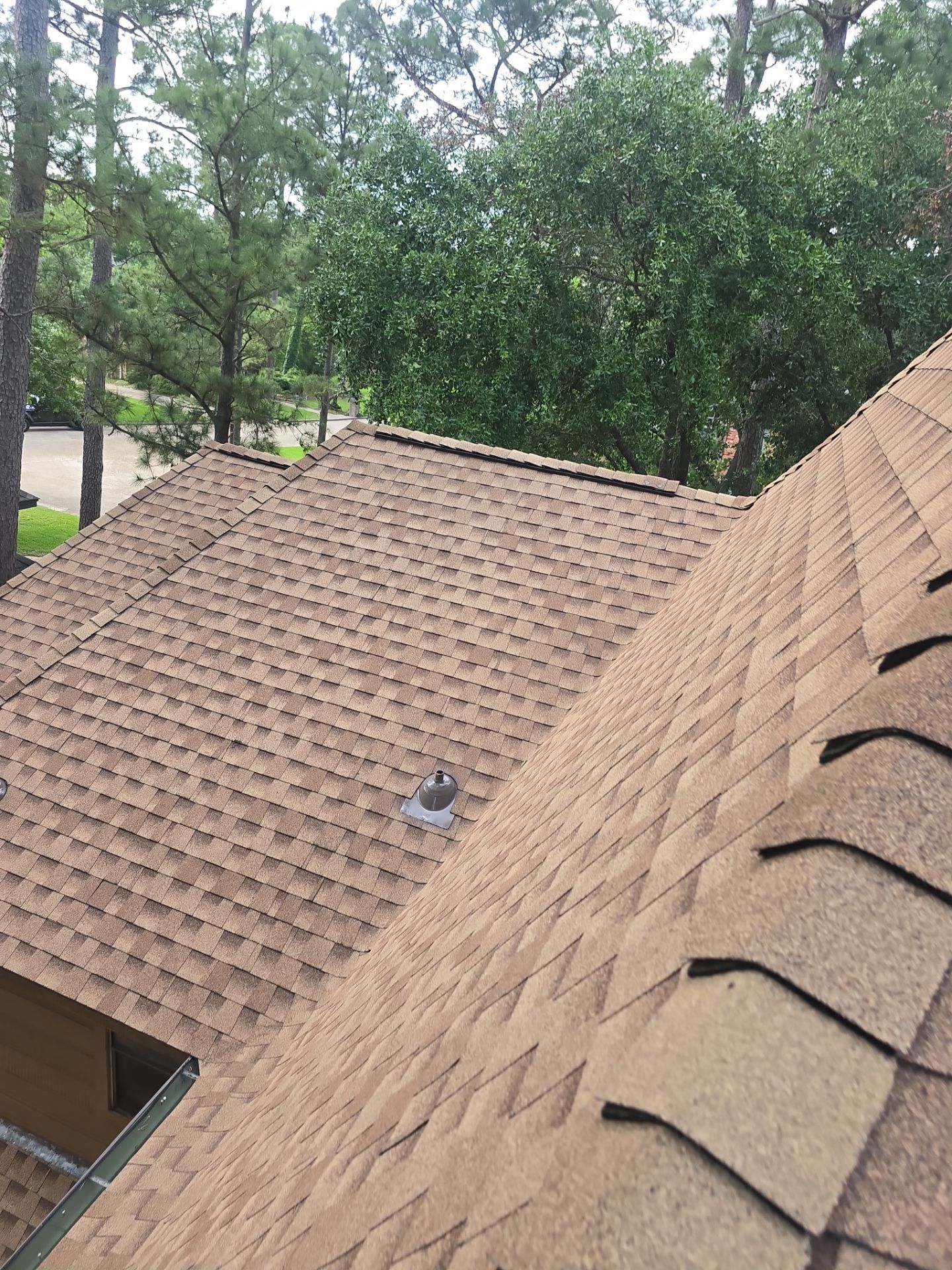 Architectural asphalt shingle roof replacement with new pipe boot flashing on a wooded lot home in The Woodlands, TX — installed by O&S Roof Repair